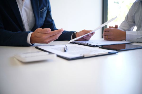 lawyer looking over injury settlement offer with client